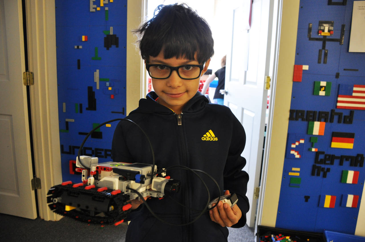 Boy shows off his robot at Empow Studios