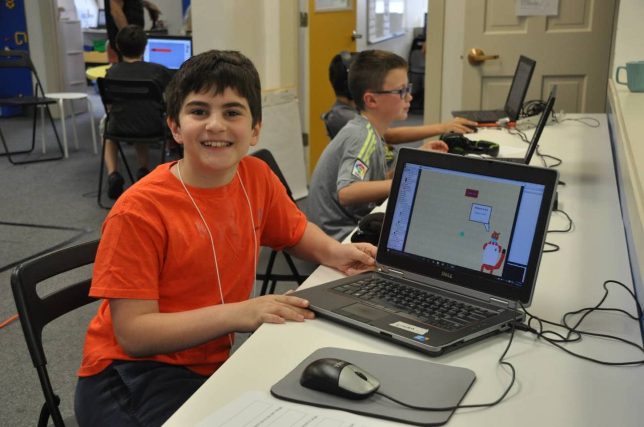 Boy showing off his Video Game Design at Empow Studios