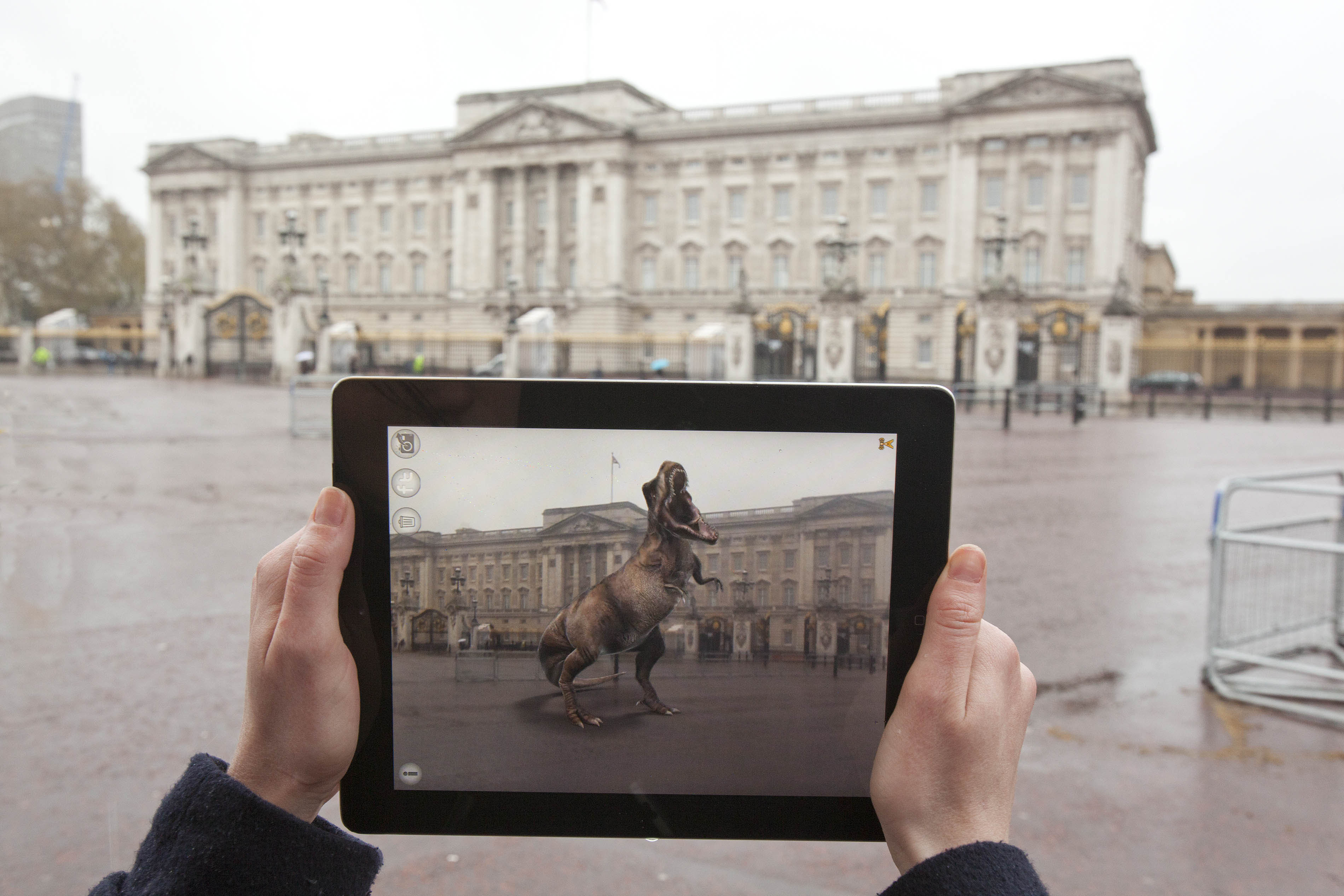 A T-Rex from Jurassic Park roars in front of Buckingham Palace. The entertainment and advertising industries have been working augmented reality into promotions and videos for several years with hopes to expand. In 2015, a Jurassic Augmented Reality experience thrilled audiences at Universal Studios in Orlando. Photo Credit: Universal Pictures and Aurasma