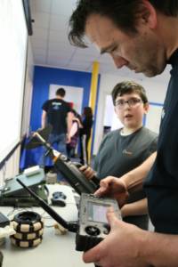 Instructor and student working with Robots at Empow Studios