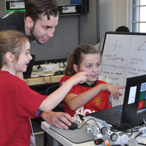 Robotics students working with Empow Studios STEM Teacher